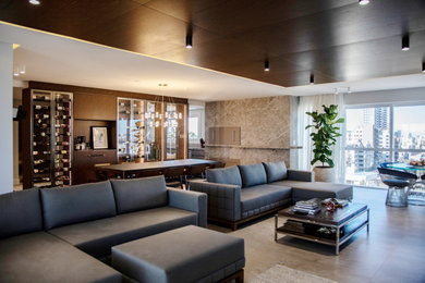 This is an example of a large contemporary open concept living room in Melbourne with brown walls, a ribbon fireplace, a wood fireplace surround, a wall-mounted tv and beige floor.