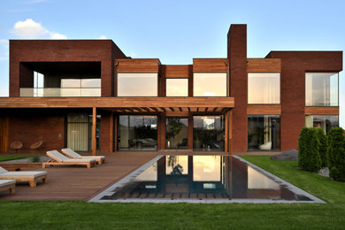 Идея дизайна: большой, двухэтажный, кирпичный, коричневый дом в современном стиле с плоской крышей