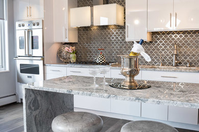 Example of a large trendy galley dark wood floor and gray floor eat-in kitchen design in Philadelphia with an undermount sink, flat-panel cabinets, white cabinets, granite countertops, black backsplash, mirror backsplash, stainless steel appliances, an island and white countertops