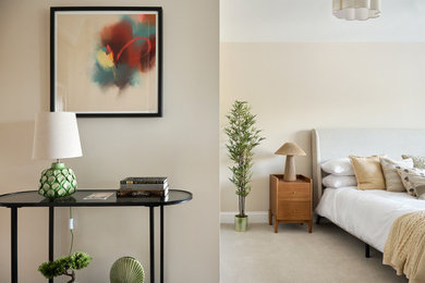 Design ideas for a medium sized modern master bedroom in Essex with beige walls, carpet, no fireplace and grey floors.