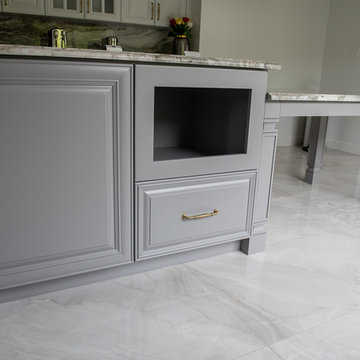 Transitional Kitchen Done in a 2 Tone Color With Integrated Dining Table