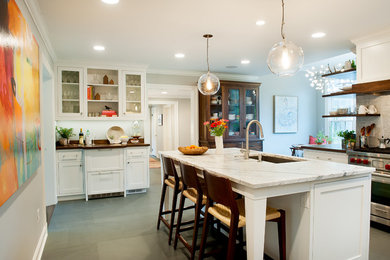 Inspiration for a mid-sized transitional slate floor eat-in kitchen remodel in Cleveland with an undermount sink, shaker cabinets, white cabinets, marble countertops, white backsplash, stone tile backsplash, stainless steel appliances and an island