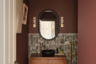 Traditional cloakroom in Other with flat-panel cabinets, medium wood cabinets, red walls, mosaic tile flooring, a vessel sink, wooden worktops, multi-coloured floors, brown worktops, a floating vanity unit and a wallpapered ceiling.