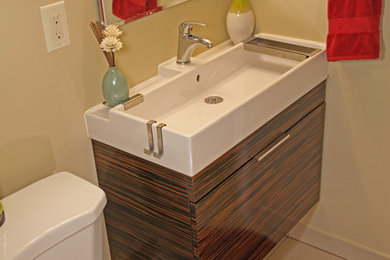 Mid-sized trendy brown tile and matchstick tile ceramic tile bathroom photo in Atlanta with flat-panel cabinets, dark wood cabinets, brown walls and a trough sink