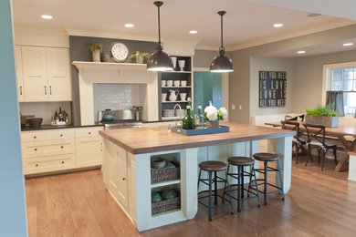 Design ideas for a beach style eat-in kitchen in Minneapolis with shaker cabinets, white cabinets, wood benchtops, white splashback and subway tile splashback.
