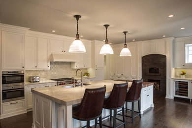 Example of a large transitional dark wood floor and brown floor eat-in kitchen design in Chicago with an undermount sink, recessed-panel cabinets, white cabinets, quartzite countertops, gray backsplash, ceramic backsplash, stainless steel appliances and an island