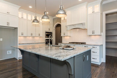 Transitional l-shaped dark wood floor eat-in kitchen photo in Raleigh with an undermount sink, gray cabinets, granite countertops, white backsplash, subway tile backsplash, an island, shaker cabinets and stainless steel appliances