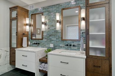 Large transitional master green tile and porcelain tile porcelain tile, black floor, double-sink and wainscoting bathroom photo in Minneapolis with flat-panel cabinets, medium tone wood cabinets, a two-piece toilet, white walls, an undermount sink, granite countertops, a hinged shower door, white countertops and a floating vanity