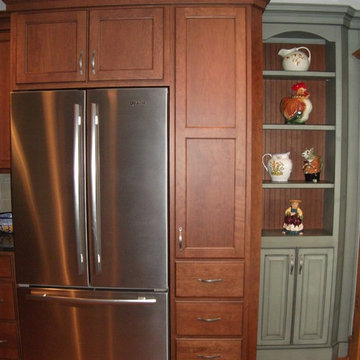 Custom depth pantry cabinet-frig garage allowing standard depth frig to look bui