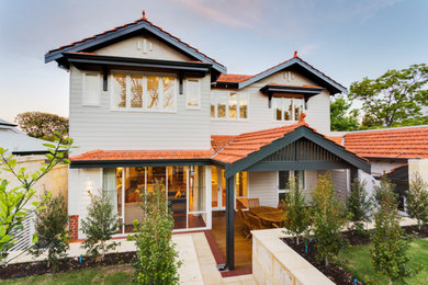 Inspiration for an expansive contemporary two-storey white house exterior in Perth with wood siding, a gable roof, a tile roof, a brown roof and board and batten siding.
