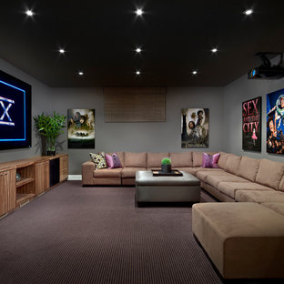 Example of a mid-sized trendy enclosed carpeted and multicolored floor home theater design in Edmonton with a projector screen and gray walls