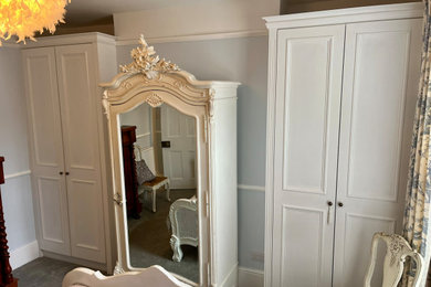 Large victorian built-in wardrobe in Kent with recessed-panel cabinets and white cabinets.
