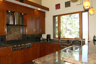 Inspiration for a transitional u-shaped medium tone wood floor enclosed kitchen remodel in Sacramento with a double-bowl sink, shaker cabinets, dark wood cabinets, granite countertops, black backsplash, ceramic backsplash and stainless steel appliances