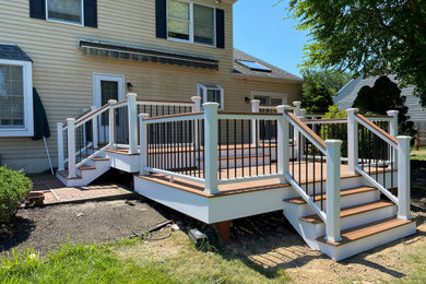Example of a large backyard deck design in Philadelphia with no cover