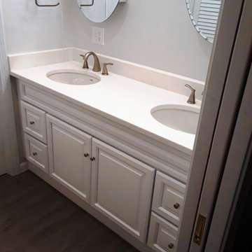 Moderately priced bath remodel with pocket doors. Calming gray tones and white.