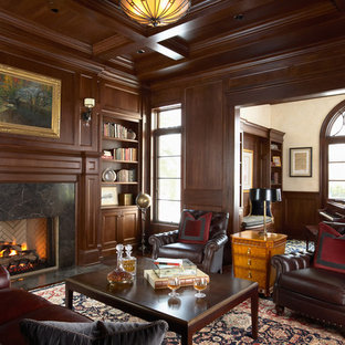 Photo of a traditional home office in Minneapolis with white walls, dark hardwood floors, a standard fireplace and a stone fireplace surround.