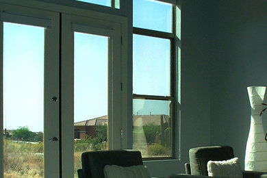 Large open concept living room photo in Phoenix with white walls