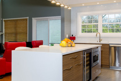 Example of a large minimalist l-shaped porcelain tile and gray floor eat-in kitchen design in Cincinnati with a double-bowl sink, brown cabinets, white backsplash, glass tile backsplash, stainless steel appliances, an island, flat-panel cabinets and quartz countertops