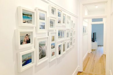 Family framed photo collection feature wall composition and hanging