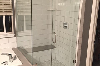 Design ideas for a mid-sized transitional master bathroom in Denver with a drop-in tub, a corner shower, white tile, subway tile, grey walls, light hardwood floors, brown floor and a hinged shower door.