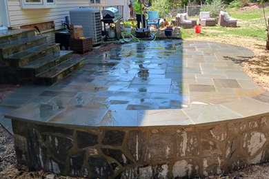 Inspiration for a mid-sized modern backyard stone patio remodel in Other with no cover