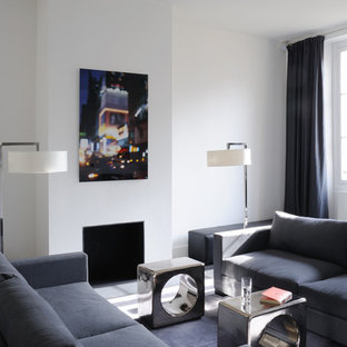 Ejemplo de salón para visitas cerrado, moderno, de tamaño medio, sin televisor, con paredes blancas y chimenea tradicional