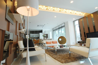 Large contemporary open concept living room in Singapore with yellow walls, marble floors and a freestanding tv.