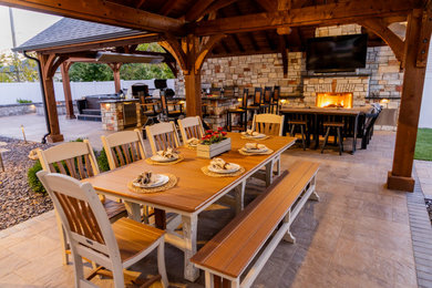 Inspiration for a huge craftsman concrete paver patio remodel in St Louis with a gazebo