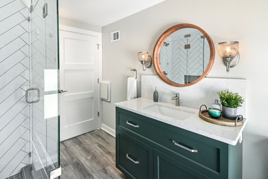 Bathroom - small contemporary master white tile and porcelain tile vinyl floor, brown floor and single-sink bathroom idea in Milwaukee with shaker cabinets, green cabinets, a two-piece toilet, beige walls, an undermount sink, quartz countertops, a hinged shower door, white countertops and a built-in vanity