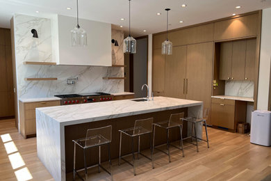 Example of a large trendy eat-in kitchen design in Seattle with flat-panel cabinets, beige cabinets and an island