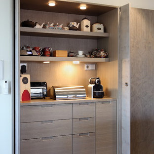 Mid-sized contemporary kitchen pantry ideas - Example of a mid-sized trendy galley porcelain floor and brown floor kitchen pantry design in Barcelona with flat-panel cabinets, medium tone wood cabinets, wood countertops, brown backsplash, wood backsplash, stainless steel appliances and an island