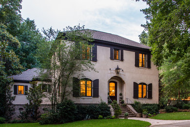 Inspiration for a two-story stucco exterior home remodel in Other
