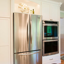refrigerator next to wall ovens