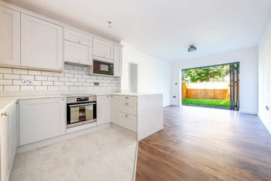 Open plan kitchen & living room with retractable glass doors to garden