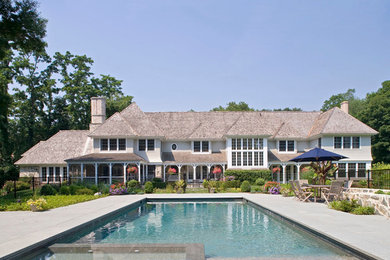 Inspiration for a large beige two-story mixed siding exterior home remodel in New York