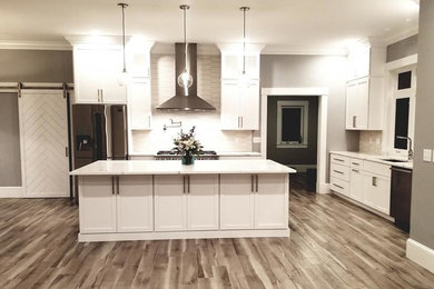 Inspiration for a transitional kitchen remodel in Other with an undermount sink, flat-panel cabinets, white cabinets, quartz countertops, white backsplash, porcelain backsplash, stainless steel appliances, an island and white countertops