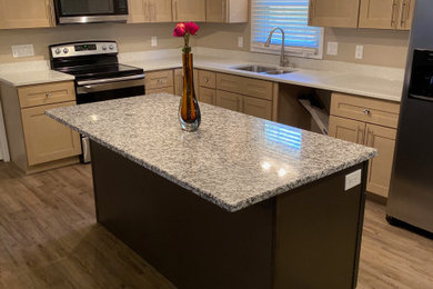 Eat-in kitchen - large modern galley vinyl floor and beige floor eat-in kitchen idea in Atlanta with an undermount sink, shaker cabinets, beige cabinets, quartz countertops, stainless steel appliances, an island and white countertops