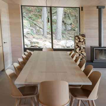 Floor-to-Ceiling Window Dining Area with Wood Fireplace