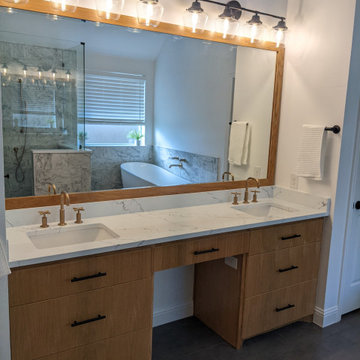 Modern primary bathroom with marble tile, curbless shower and custom vanity