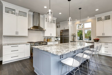Eat-in kitchen - large contemporary l-shaped medium tone wood floor and gray floor eat-in kitchen idea in Houston with a farmhouse sink, shaker cabinets, white cabinets, quartzite countertops, white backsplash, subway tile backsplash, stainless steel appliances, an island and gray countertops