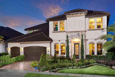 Large contemporary beige two-story stucco exterior home idea in Orlando