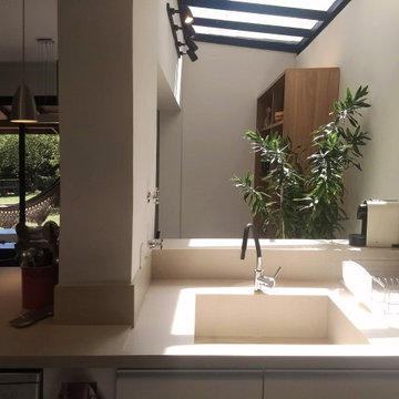 Modern Bespoke Kitchen Design with Wood, Plants, and Skylight