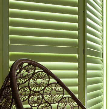 Lime Green Window Shutters with Rattan Chair