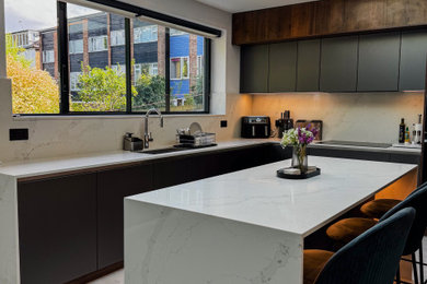 Photo of a medium sized grey and brown l-shaped open plan kitchen in London with a built-in sink, glass-front cabinets, dark wood cabinets, quartz worktops, white splashback, engineered quartz splashback, black appliances, porcelain flooring, an island, grey floors, white worktops and exposed beams.