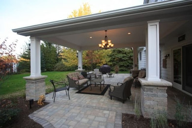 Mid-sized backyard brick patio kitchen photo in Cleveland with a roof extension