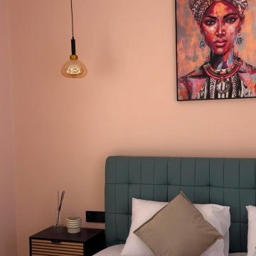 Blush Pink Guest Bedroom with Sage Green Tufted Velvet Bed & African Art Decor