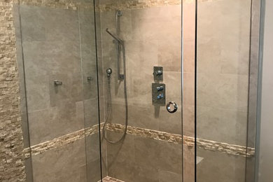 Design ideas for a mid-sized traditional master bathroom in Miami with beige tile, stone tile, an alcove shower, beige walls and a sliding shower screen.