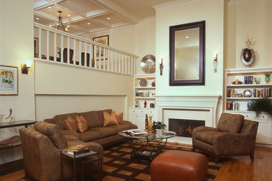 Traditional living room in San Francisco with beige walls, medium hardwood floors, a standard fireplace and no tv.