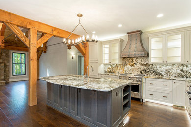 Open concept kitchen - mid-sized craftsman u-shaped dark wood floor and brown floor open concept kitchen idea in Richmond with a farmhouse sink, recessed-panel cabinets, white cabinets, granite countertops, multicolored backsplash, stone slab backsplash, stainless steel appliances, an island and multicolored countertops