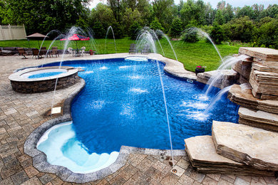 Pool fountain - large modern backyard tile and custom-shaped pool fountain idea in Ottawa